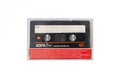 Red AGFA audio cassette, retro audio technology, on white background