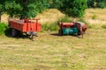 agricultural tractor trailers on green meadow Royalty Free Stock Photo