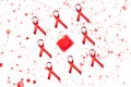 Red AIDS ribbon and condom with red splashes on white background. World AIDS Day concept