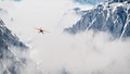 Red airplane flying over snow mountains in the clouds. Royalty Free Stock Photo