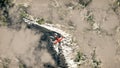 Red airplane flying over snow mountains with pine trees in the clouds. Royalty Free Stock Photo