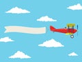 Red airplane with pilot and advertising banner in the cloudy sky Royalty Free Stock Photo