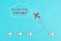 Red airplanes takes a different direction, flying to the cloud with the phrase follow your dreams, motivation and coaching concept Royalty Free Stock Photo