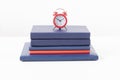 Red alarm clock, books on table. Time management concept