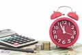 Red alarm clock and Calculator on money banknotes Euro and Dolla Royalty Free Stock Photo