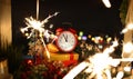 Red alarm clock with christmas gifts against night Royalty Free Stock Photo