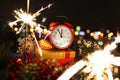 Red alarm clock with christmas gifts against night Royalty Free Stock Photo