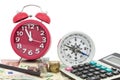 Red alarm clock with compass ,coins and Calculator on money bank Royalty Free Stock Photo