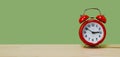 Red alarm clock on a green background, web banner