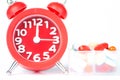 Red alarm clock and pill box Royalty Free Stock Photo