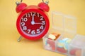 Red alarm clock and daily pill box Royalty Free Stock Photo