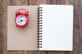 The red alarm clock placed on the cover of the address book for recording. Time management concepts Writing notes at important Royalty Free Stock Photo
