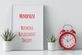 A red alarm clock sitting next to a poster, text Menopause, Hormone Replacement Therapy. Royalty Free Stock Photo