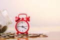 Red alarm clock on stack of coins in concept of savings and money growing or energy save. Business investment growth concept. Royalty Free Stock Photo