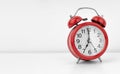 Red alarm clock on white wall background Royalty Free Stock Photo