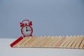 Red alarm-clock on wooden blocks in line, copy space. Time passing. Business deadline, time-limit. Running out of time Royalty Free Stock Photo