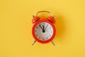 Red alarm clock on yellow background. Royalty Free Stock Photo