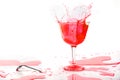 Red alcohol cocktail drink splash on white background. Royalty Free Stock Photo