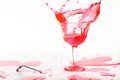 Red alcohol cocktail drink splash on white background. Royalty Free Stock Photo