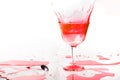 Red alcohol cocktail drink splash on white background. Royalty Free Stock Photo