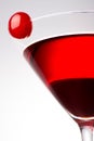 A red alcoholic cocktail with a cherry on the glass isolated on a white background Royalty Free Stock Photo