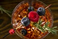 Red Alcoholic Cocktail with Raspberry and Aperol. Garnished with Fresh Rosemary branch and blueberries. Top view with selective Royalty Free Stock Photo