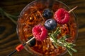 Red Alcoholic Cocktail with Raspberry and Aperol. Garnished with Fresh Rosemary branch and blueberry. Top view with selective Royalty Free Stock Photo