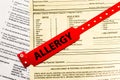 Allergy Bracelet Over Hospital Paperwork