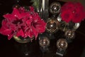 Red amaryllis, red roses, golden illuminated balls, dark background. Festive romantic arrangement for advent and Christmas. Royalty Free Stock Photo