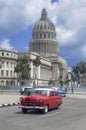 Red american car in front of the Capitolio in Havana, Cuba Royalty Free Stock Photo