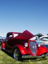 Red American Hotrod in grass Royalty Free Stock Photo