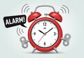 Red analog alarm clock with two bells, featuring a white clock face with black numbers and hands, Royalty Free Stock Photo
