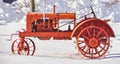 Red Antique Farm Tractor Sitting in the Snow