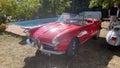 Red, antique Triumph Spitfire in the exhibition of historic, vintage cars in the countryside