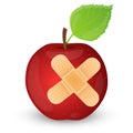 Red apple with adhesive bandage. Royalty Free Stock Photo