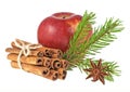 Red apple, anise star, cinnamon sticks and fir-tree branch on a white background. Christmas decoration Royalty Free Stock Photo