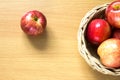 Red apple in basket on wood background Royalty Free Stock Photo
