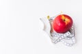 Red apple bind with tape measure for concept loss weight and diet healthy Royalty Free Stock Photo