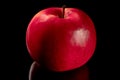 red Apple on black background with close-up reflection Royalty Free Stock Photo