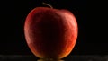 Red apple on a black background with reflection close up Royalty Free Stock Photo