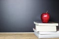 Red apple on book with Blackboard Chalk Board as background Royalty Free Stock Photo