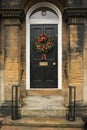 Red apple and chillies wreath on a black door