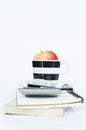 Red Apple in cup and calculator and book notes on white backgrounds vertical