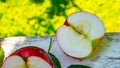 Red apple cut in half with water drops on an old table, close up, copy space, background Royalty Free Stock Photo