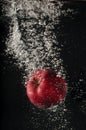 Red apple falling into water Royalty Free Stock Photo