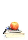 Red apple fruits on book stack and calculator with glasses Royalty Free Stock Photo