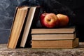 Back to school, Red Apple fruits on top of Book on Stack of Books with chalk board Royalty Free Stock Photo