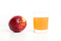 Red apple with glass of naturally cloudy juice