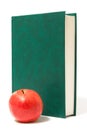 Red apple and green book