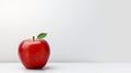 Red apple with green leaf on white table against white wall background Royalty Free Stock Photo